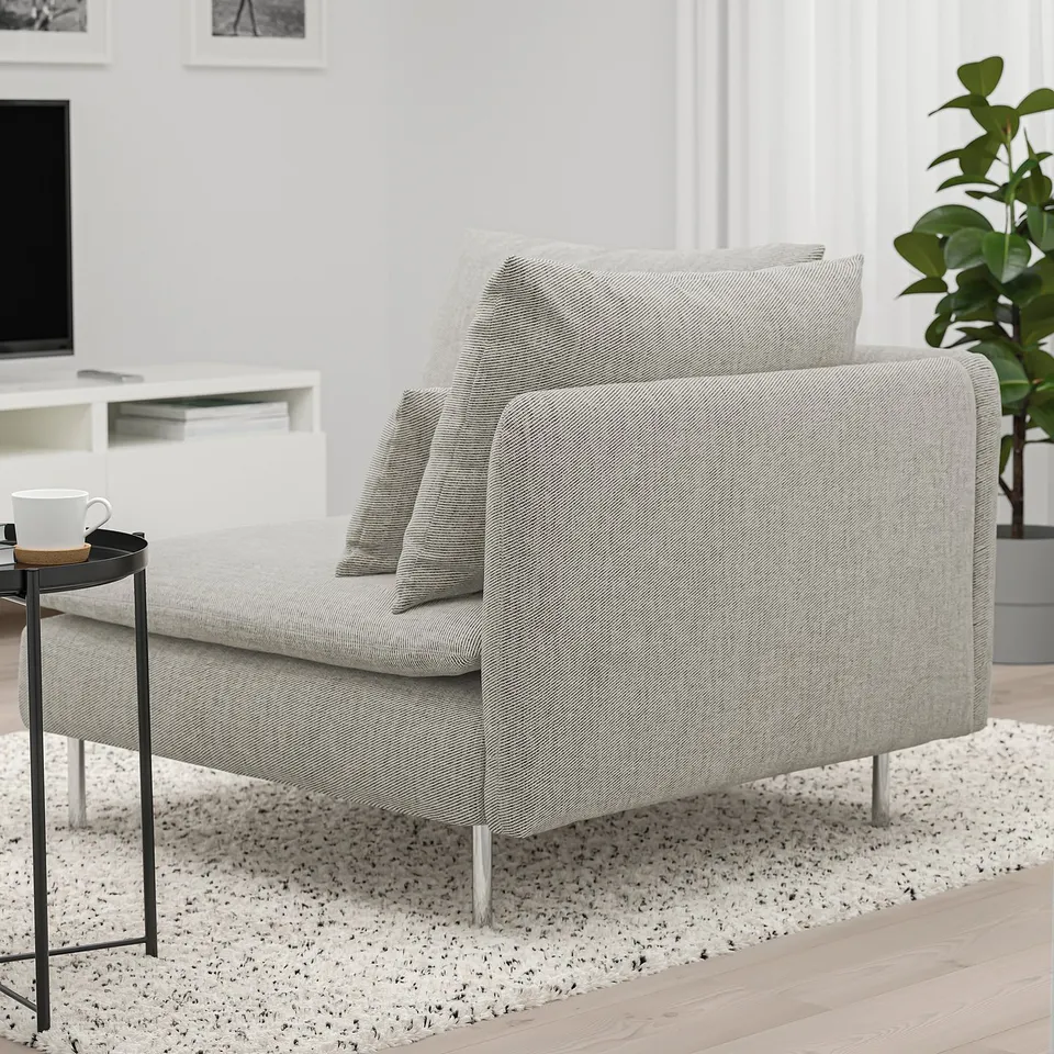 Modern sofa with plush cushions, stylish legs, cosy for relaxation; includes side table with mug.