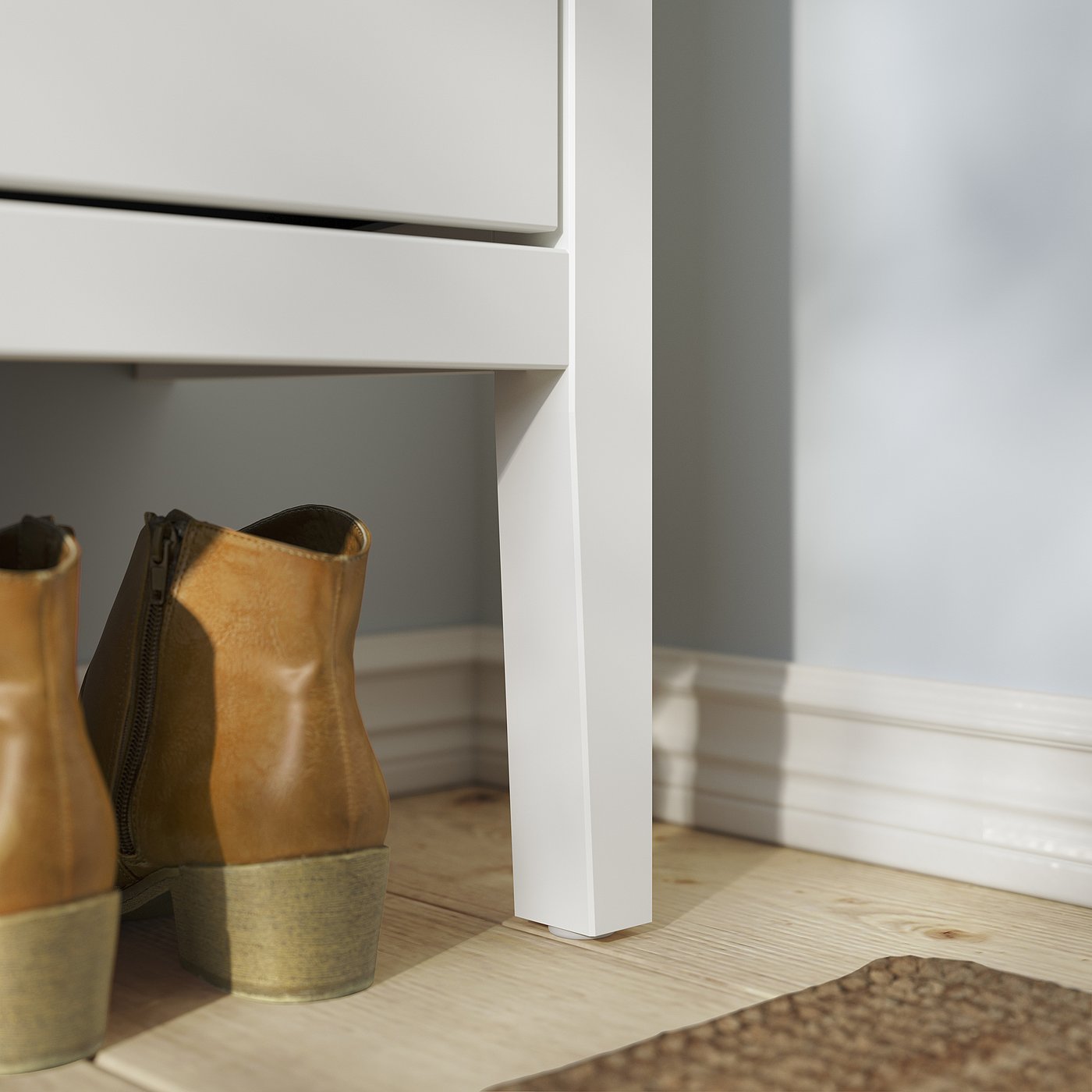 White GULLABERG shoe cabinet with tan boots. Clean, modern design with crafted details.