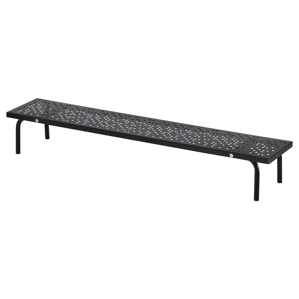 A black LÅNESPELARE gaming monitor stand with a perforated surface, four metal legs, and a sleek, rectangular design.
