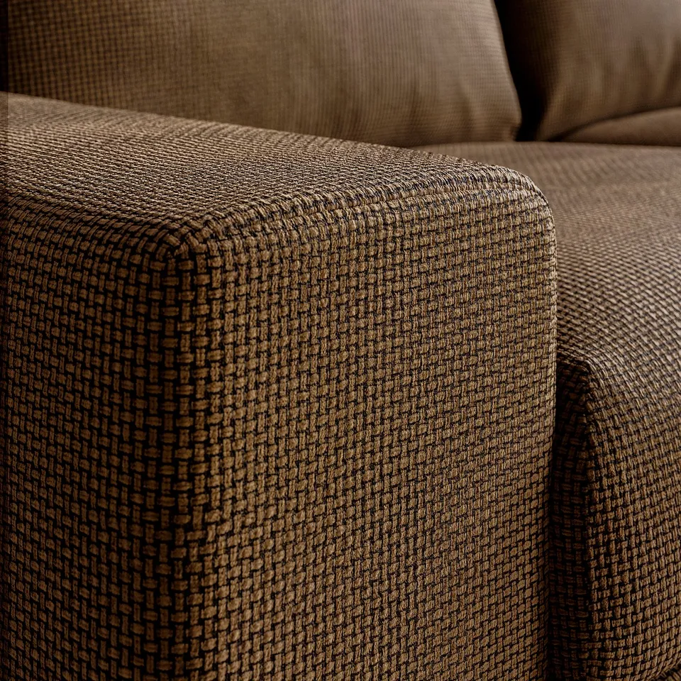 Comfy couch detail: brown tweed texture with neat stitching, soft cushions.