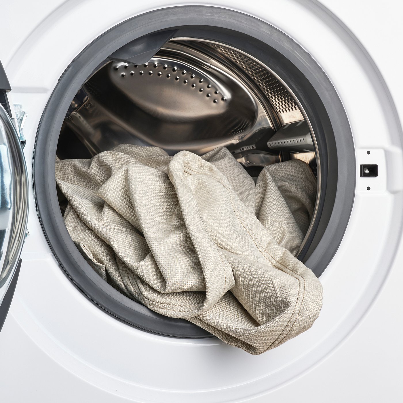 Machine washable bed cover inside open dryer, easy to clean and replace.
