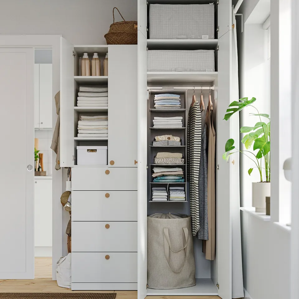 Organised closet with STUK shelves holding folded clothes and accessories. Clothes hangers visible with neatly folded garments.