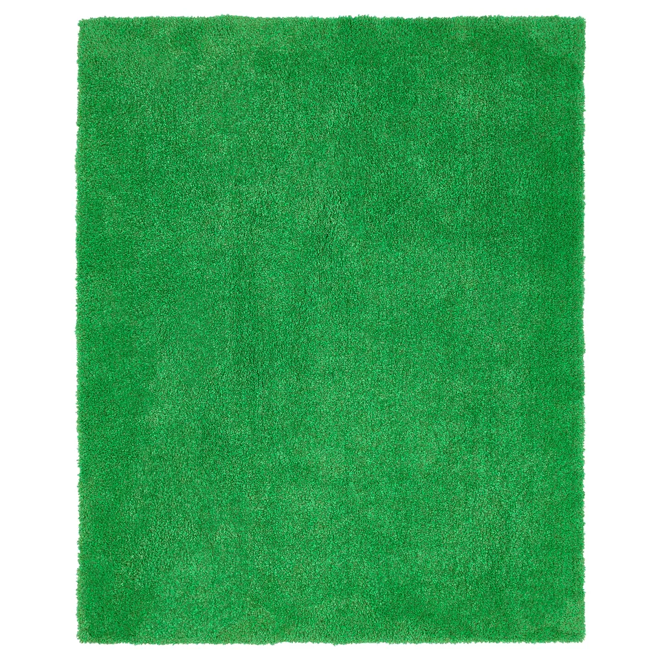 Bright green, rectangular, plush indoor/outdoor rug with a textured, grass-like surface.