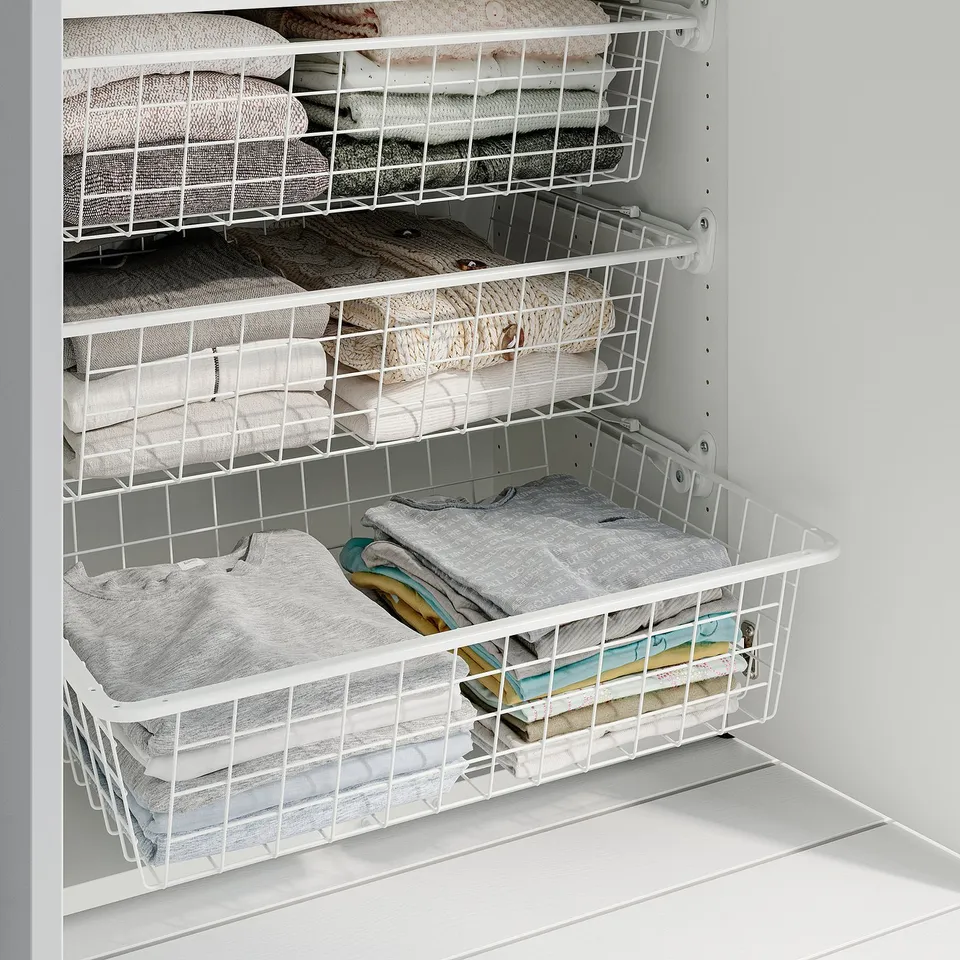 Wire baskets in closet hold folded clothes neatly, allowing air circulation for freshness. Adjustable for versatile storage.