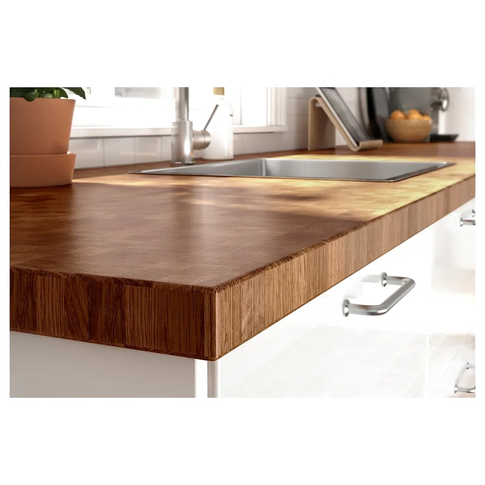 Modern kitchen countertop with wooden texture, stainless sink, white cabinets, handles.