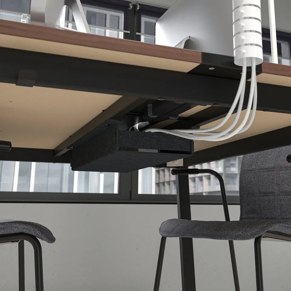 Under-table cable management of MITTZON conference table, ensuring organised and accessible power supply.