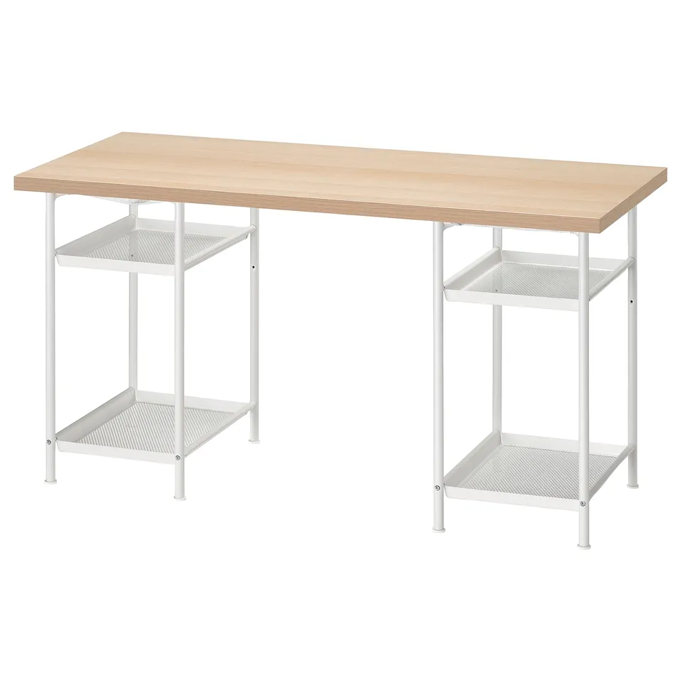 An IKEA LAGKAPTEN desk with a light wood top and white metal legs featuring shelves.