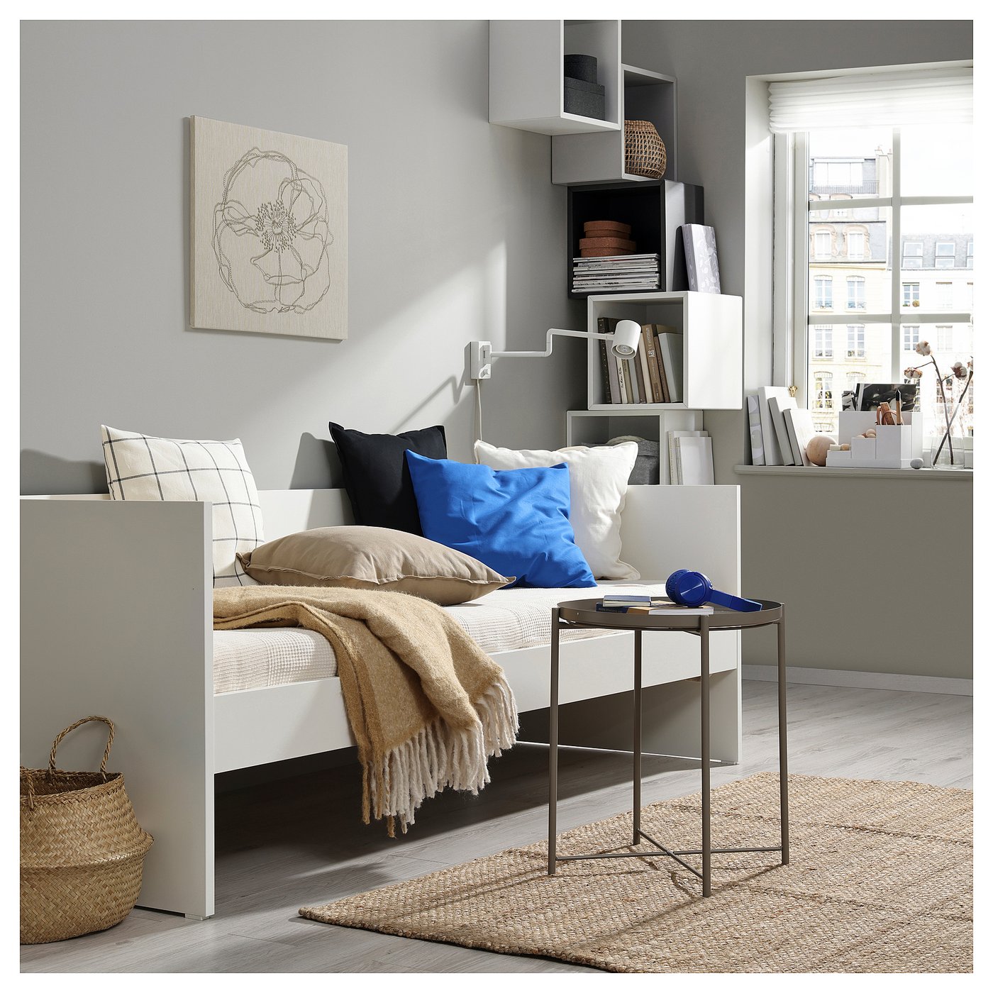 Small modern bed with shelves and pillows, a bedside table, and a rug.
