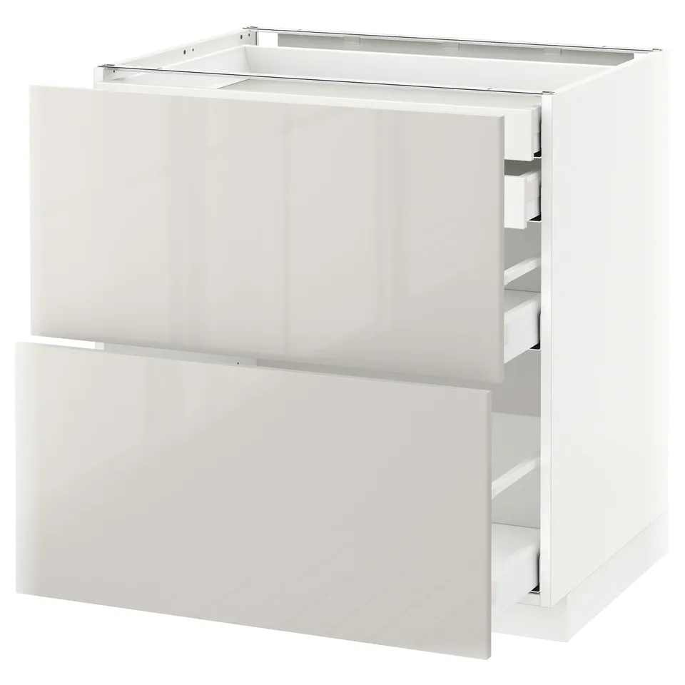 A white METOD kitchen cabinet with a glossy finish featuring two drawers. It has a modern design with sleek lines and a durable construction.
