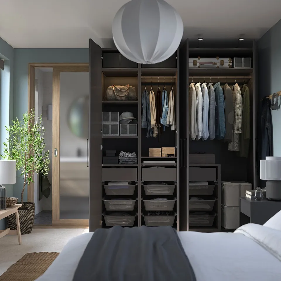 Organised bedroom with black wardrobe, led lights, round lamp, white bed, green plant, teal walls.