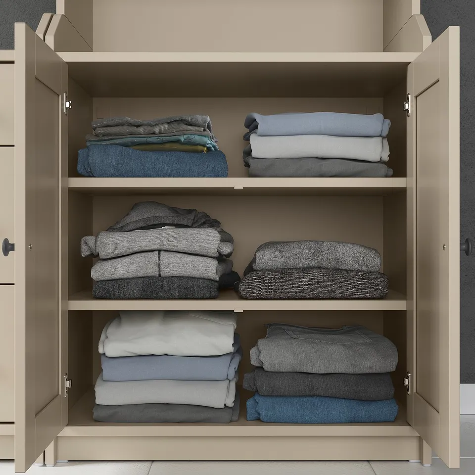 Modern closet with six shelves storing folded clothes, light beige.