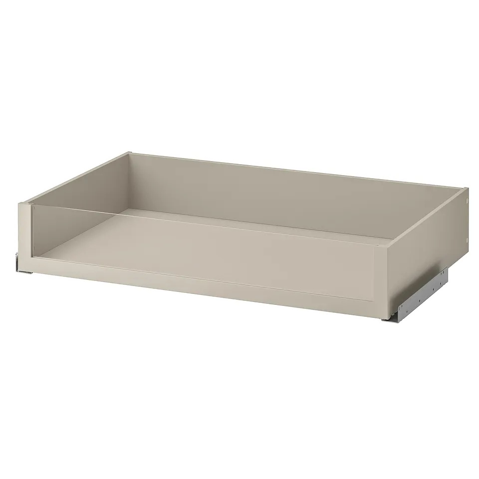 An empty beige drawer with a glass front from IKEAs KOMPLEMENT series. It has a modern, rectangular design.