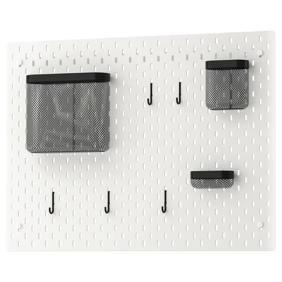 SKÅDIS pearl white pegboard, organised with black hooks and mesh baskets, featuring modern storage solution.