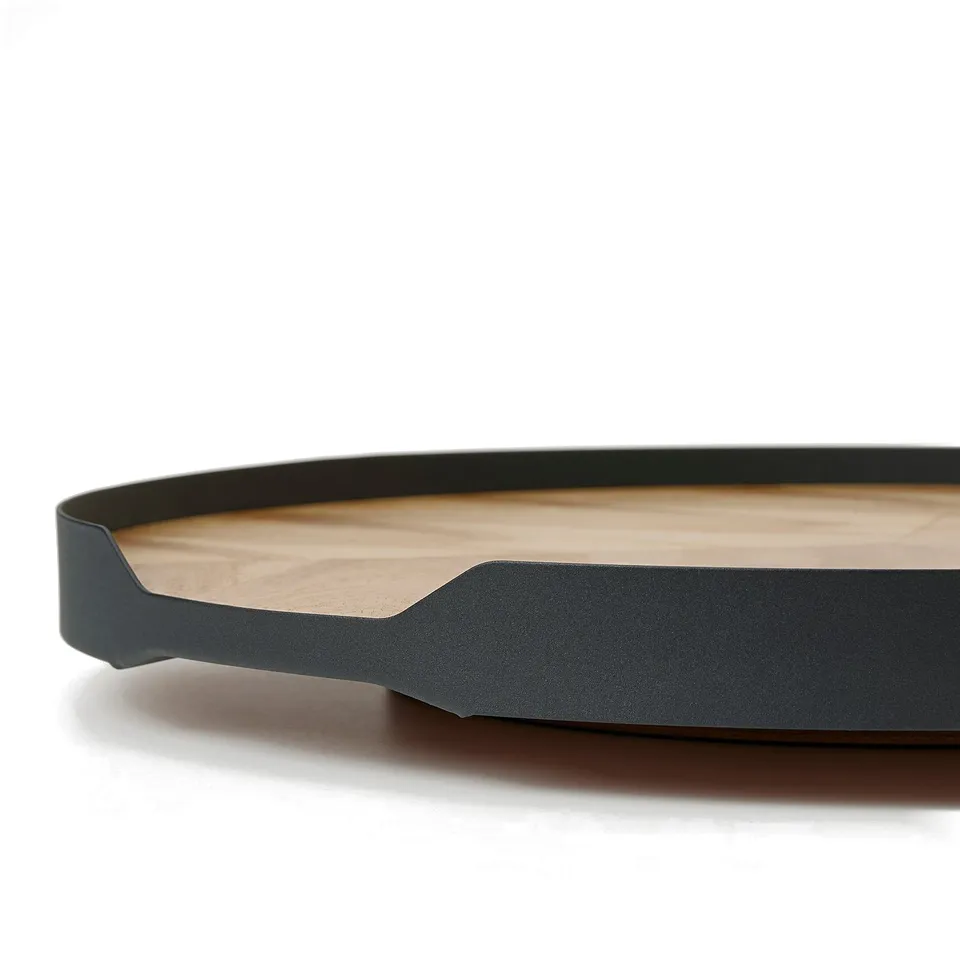 Modern round wooden tray with dark metal edge; smooth, natural finish.
