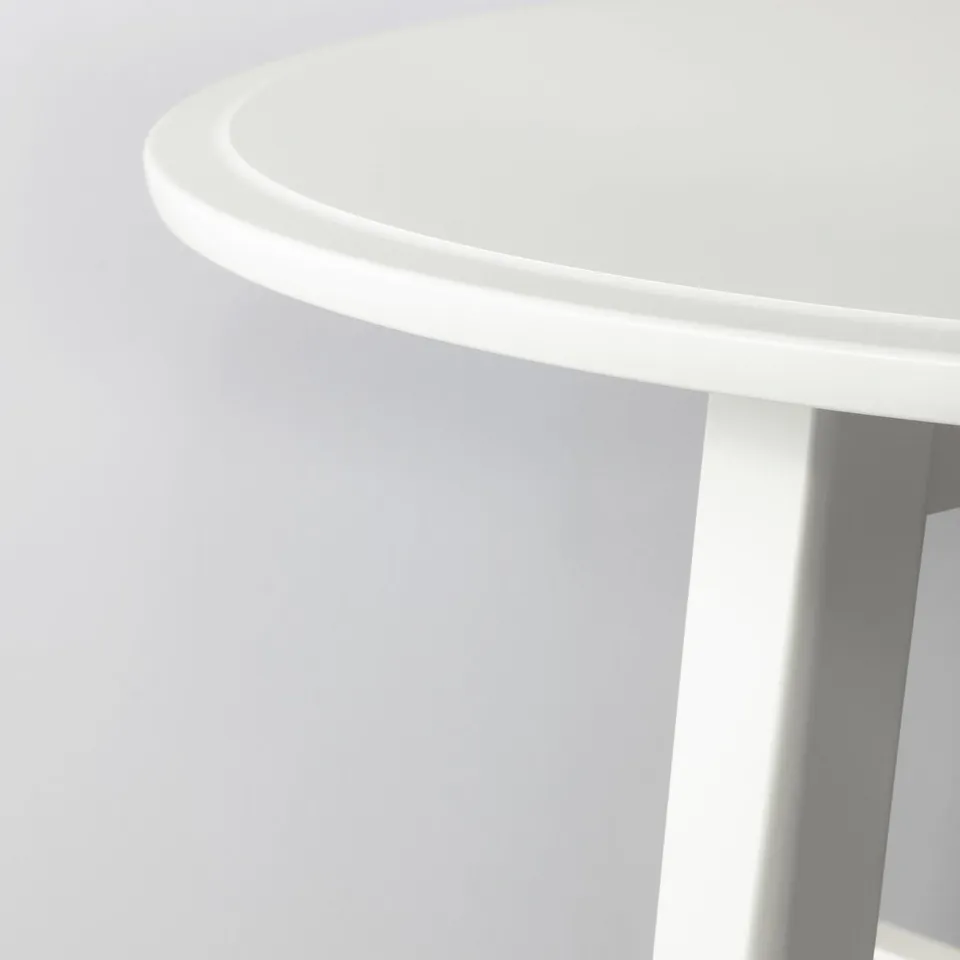 Modern white coffee table with smooth edges. Sturdy, round design, clean finish.