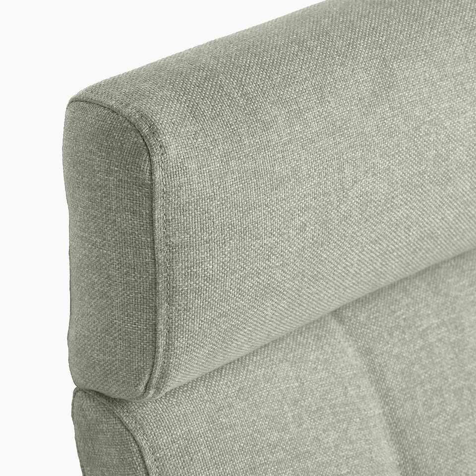 Close-up of upholstered sofa corner, showing plush, textured fabric and sturdy stitching.