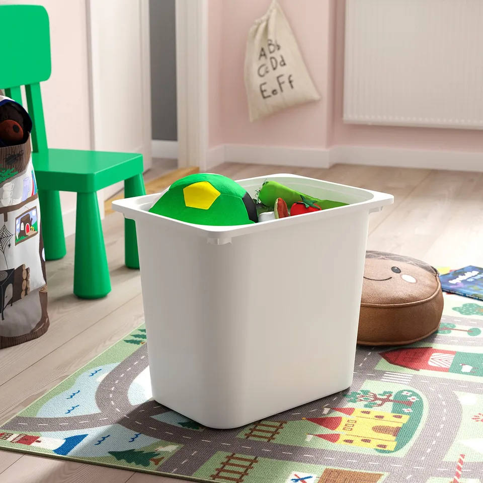 White TROFAST storage box, filled with colourful toys, on a play rug.