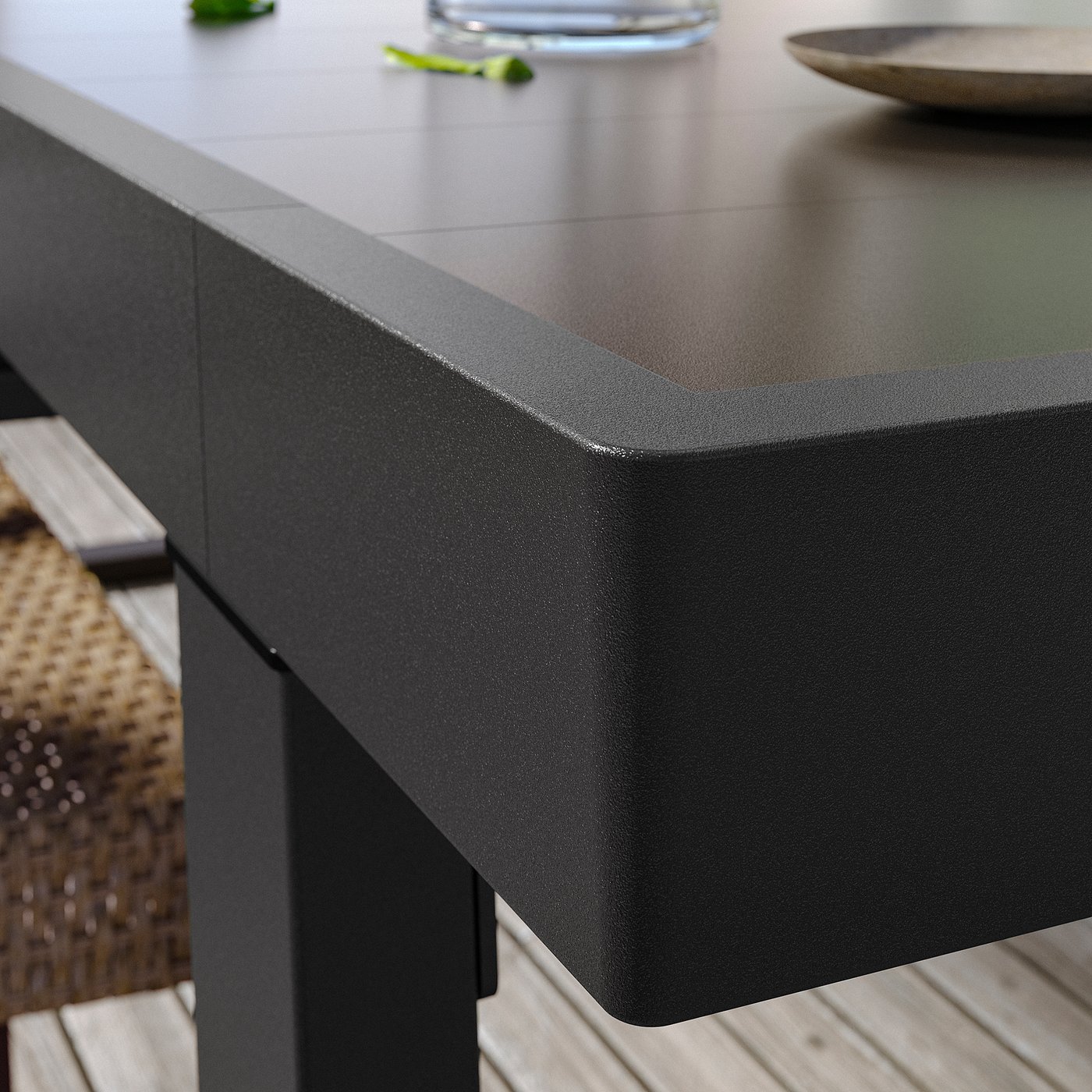 Black outdoor table, modern design, square edges, made of aluminium, seats 4-6.