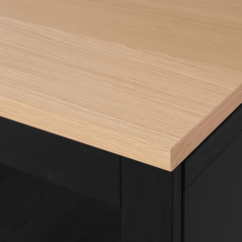 Modern sideboard with smooth, light-colored wood top and sleek black base; high-quality finish.