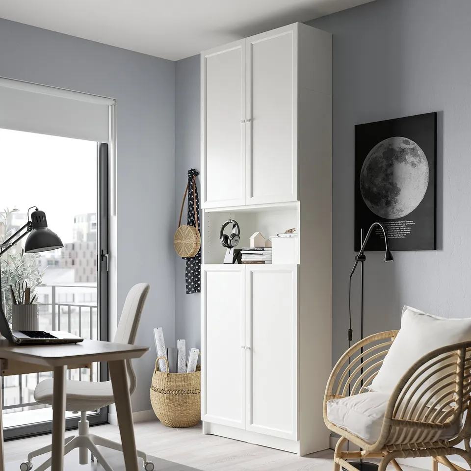 Minimalist home office with BILLY bookcase, laptop desk, chair, city view, moon poster.