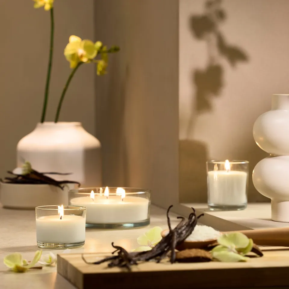 LOTSFÅGEL Scented candle in glass, Vanilla pale beige, 20 hr