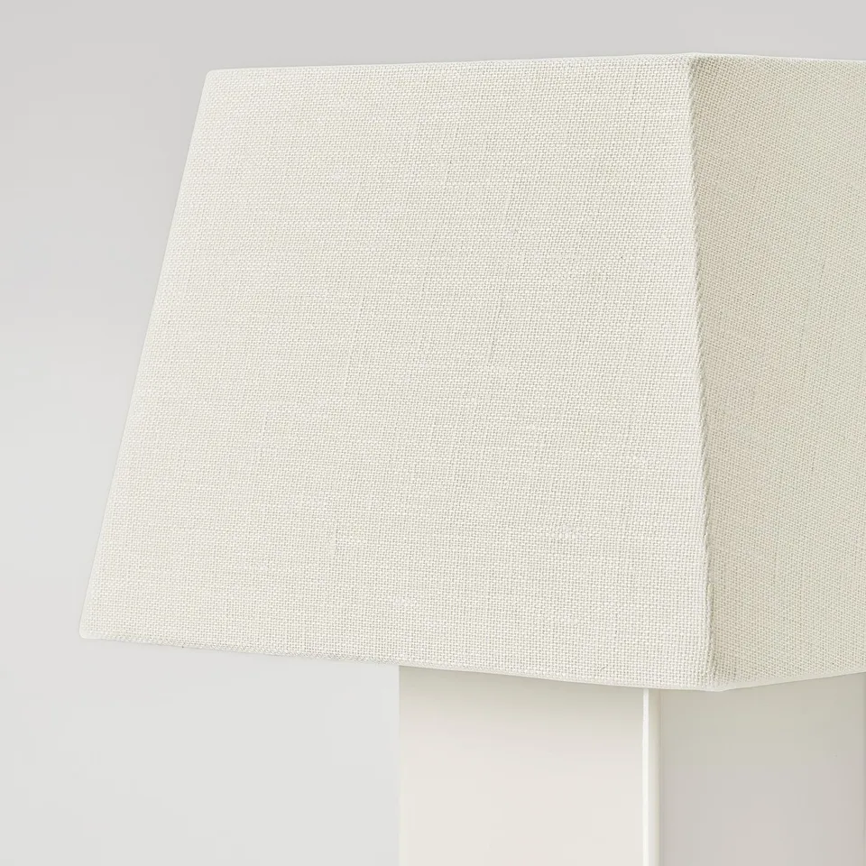 Close-up of elegant lamp shade. Soft, textured linen in warm white, reflecting quality craftsmanship.