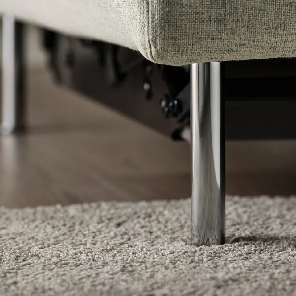 Modern sofa with metal legs on textured rug. High-quality, sleek design.