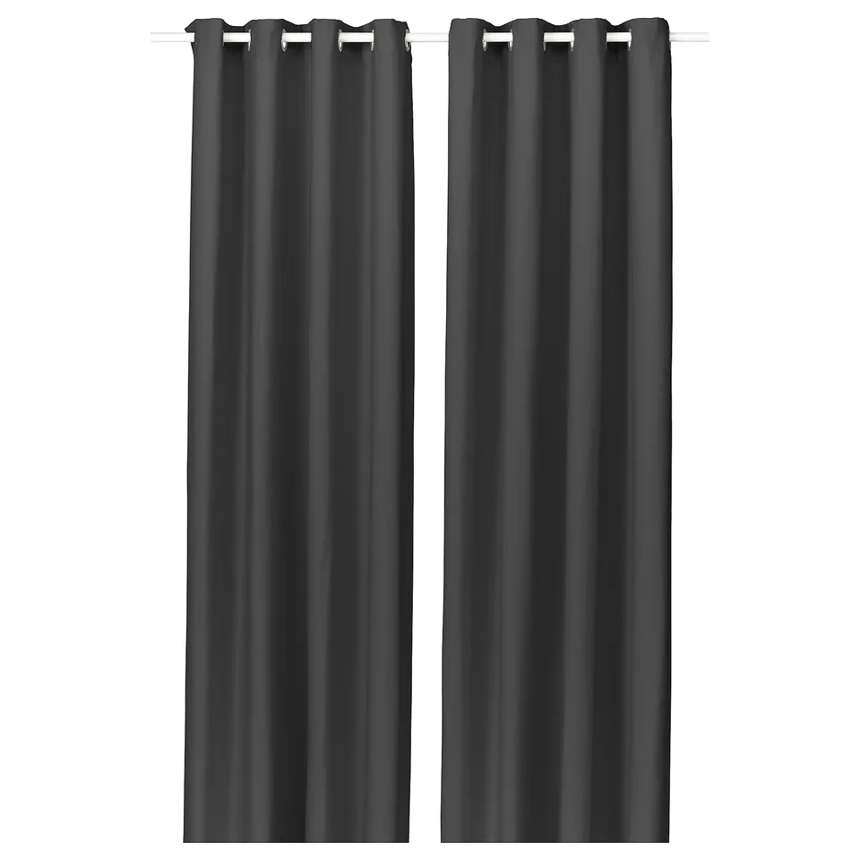 Two dark grey GINSTMOTT curtains hang straight, featuring modern eyelets for a sleek, clean look.