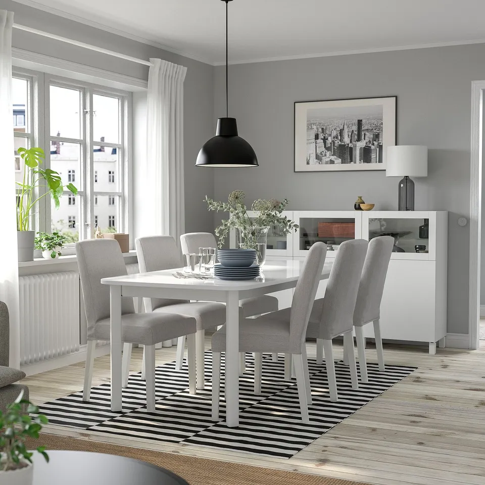 STRANDTORP white dining set with extendable table, grey chairs, striped rug, and plants.