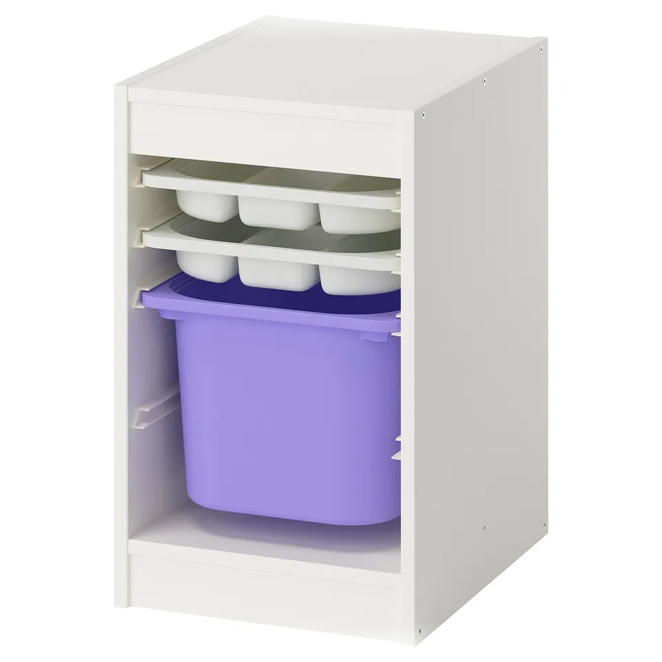 A white TROFAST storage unit with purple bins and white trays. Its designed for kids, featuring open shelves for easy access.