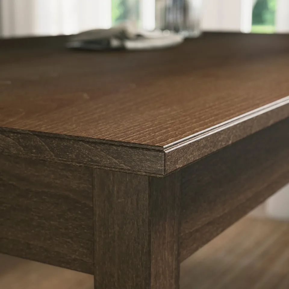 Close-up of dark wooden table edge, smooth finish, clear varnish.