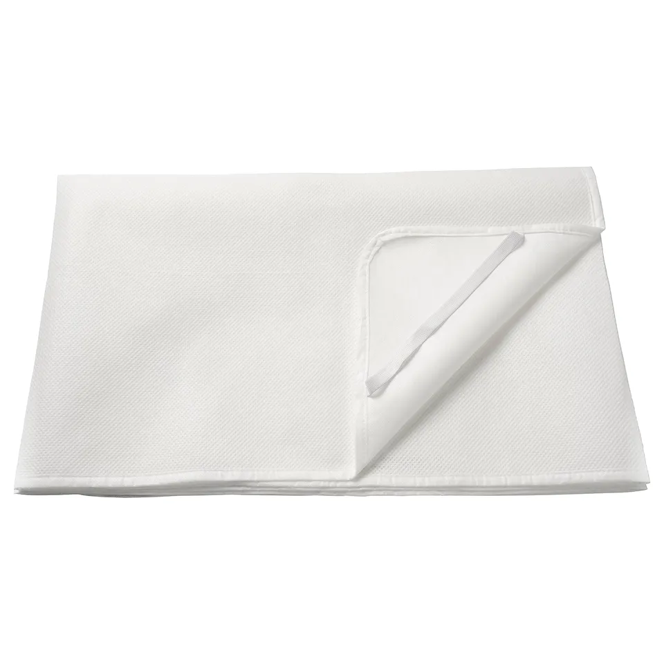 Folded white mattress protector, rectangular with wipe-clean surface, made of polyurethane and polyester, designed to fit snugly on mattresses.