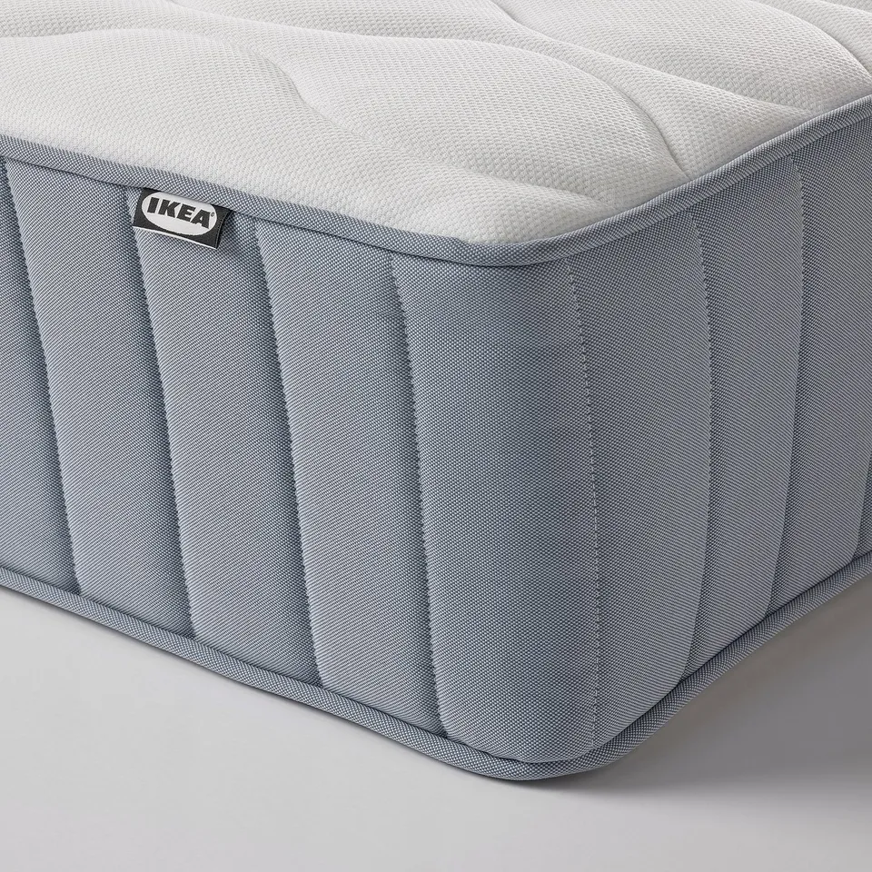 Close-up of a firm mattress corner, showcasing its sturdy design and quality craftsmanship.