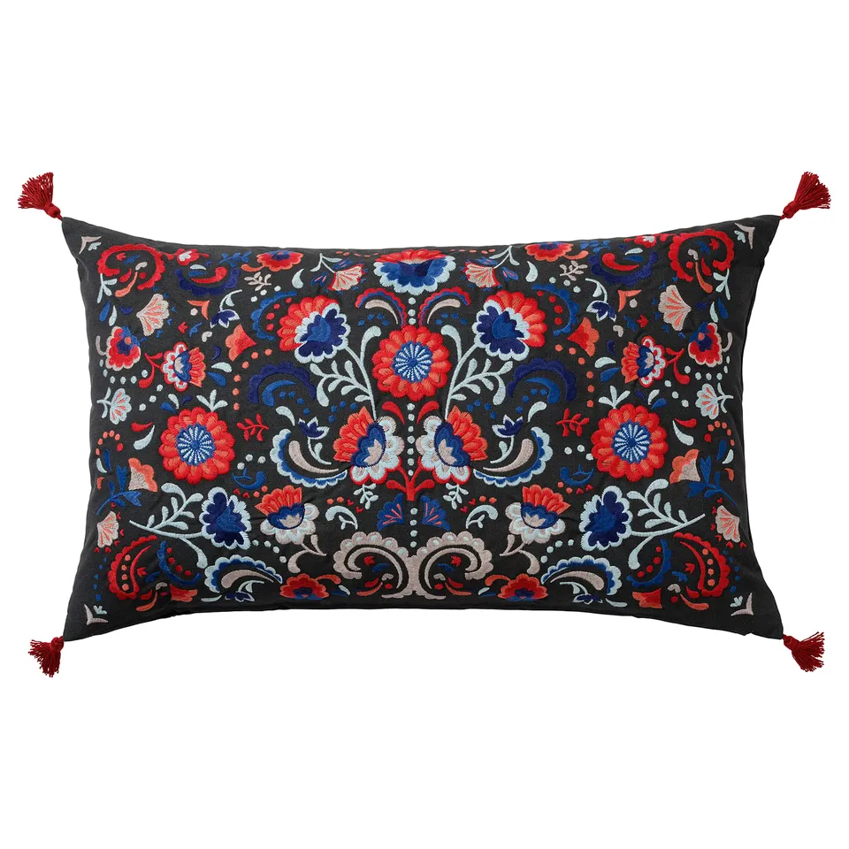 Skc cushion: black cotton, red/blue/white floral, red tassels, duck feather filling.