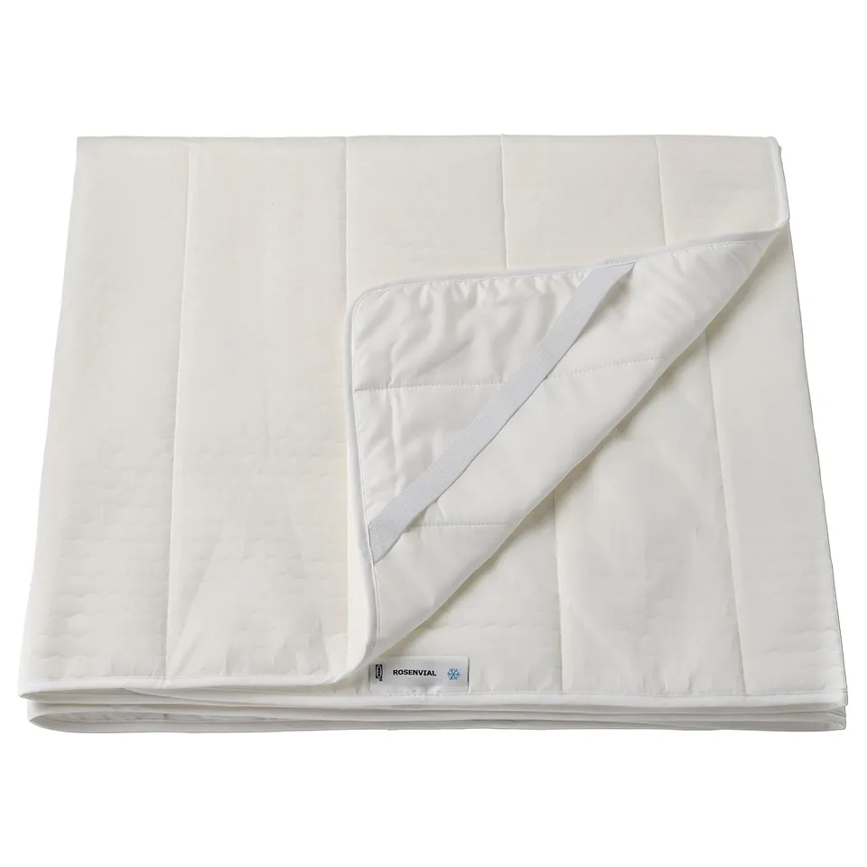 A white ROSENVIAL mattress protector, rectangular with quilted design, made from polyester and nylon, folded neatly.