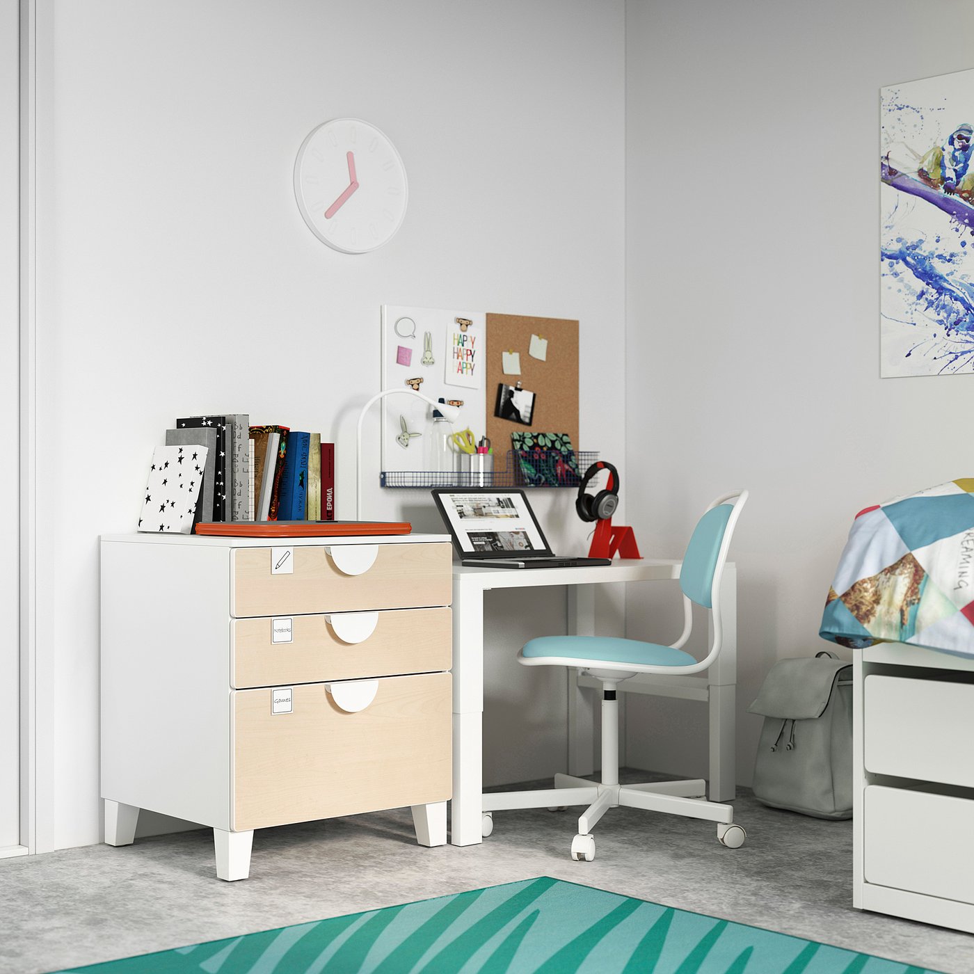 A childs study area with a white and beige desk, blue chair, and colourful decor.