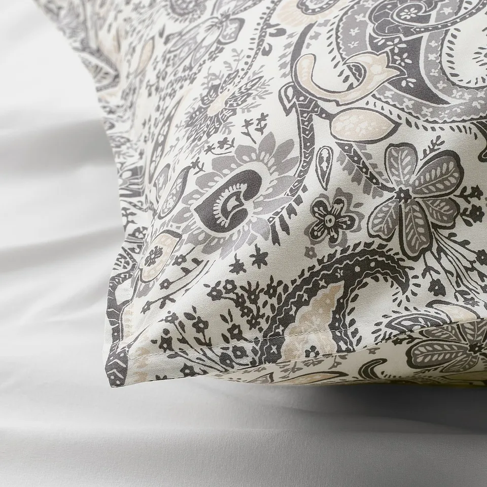 Decorative pillowcase with intricate paisley design in neutral tones, showcasing high-quality fabric and detailed patterns.