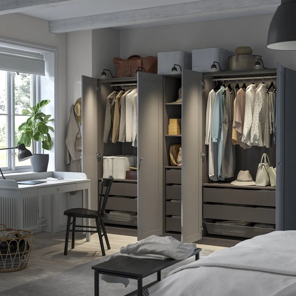 Modern wardrobe with open doors, showcasing clothes and accessories on hanging rails and shelves.
