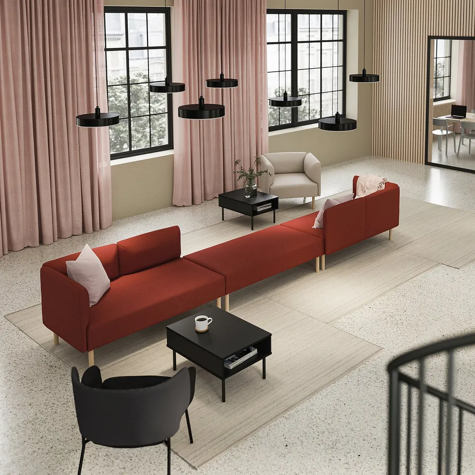 Modern room with a red LILLEHEM modular sofa, black coffee tables, black pendant lights, and large windows with pink curtains.