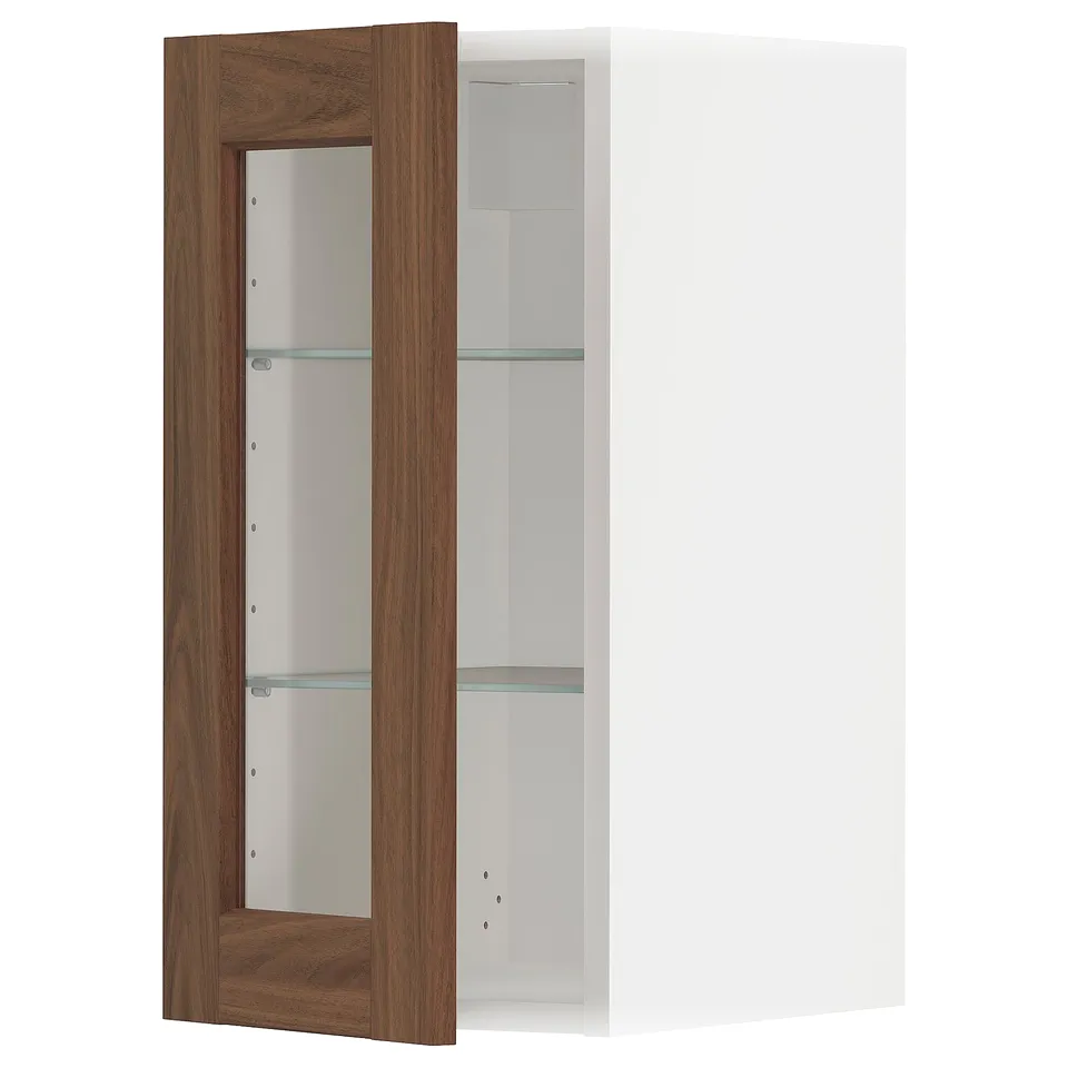 A METOD wall cabinet with a white frame and a walnut-finished glass door featuring adjustable shelves.