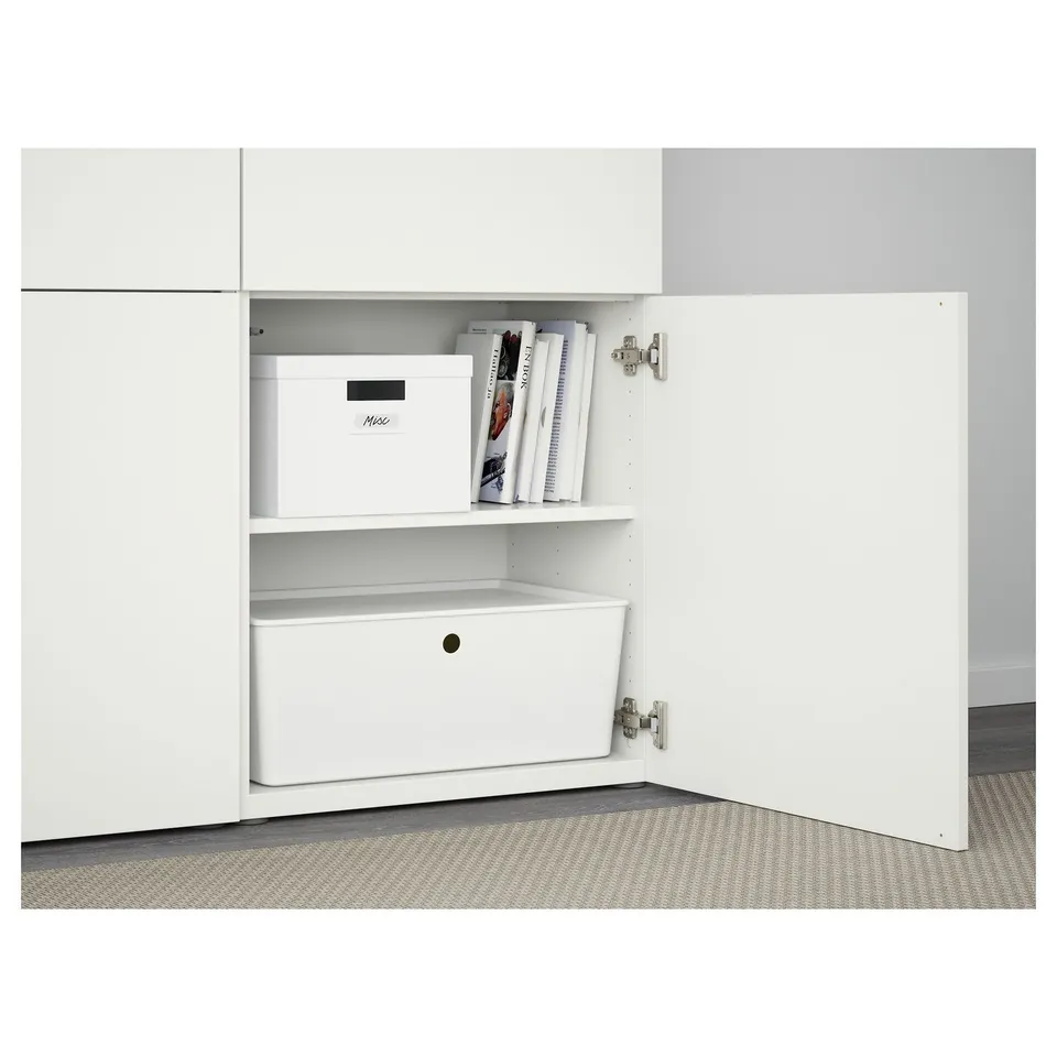 White BESTÅ cabinet with shelves and storage box. Soft-close hinges visible, one shelf adjustable.
