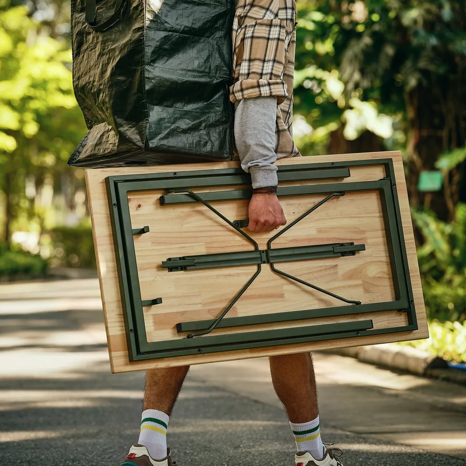 Folding table with carrying handle and side hooks, ideal for moving and storage.