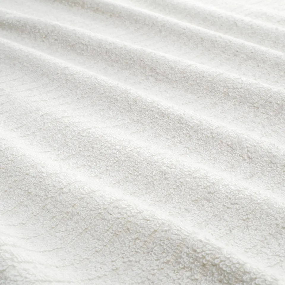 Close-up of soft, striped towel with terry texture. Highlights its soft, absorbent quality.