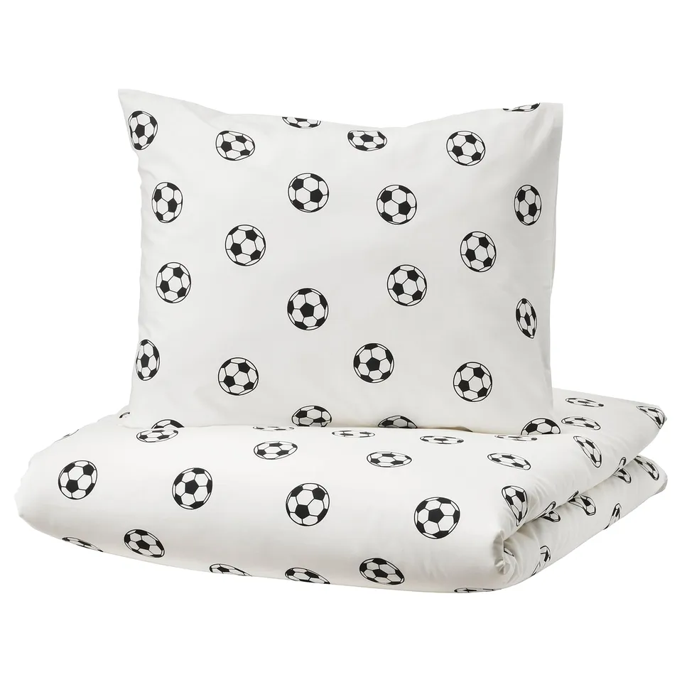 White duvet & pillowcase set, black football prints. 80% cotton, soft & moisture-wicking.