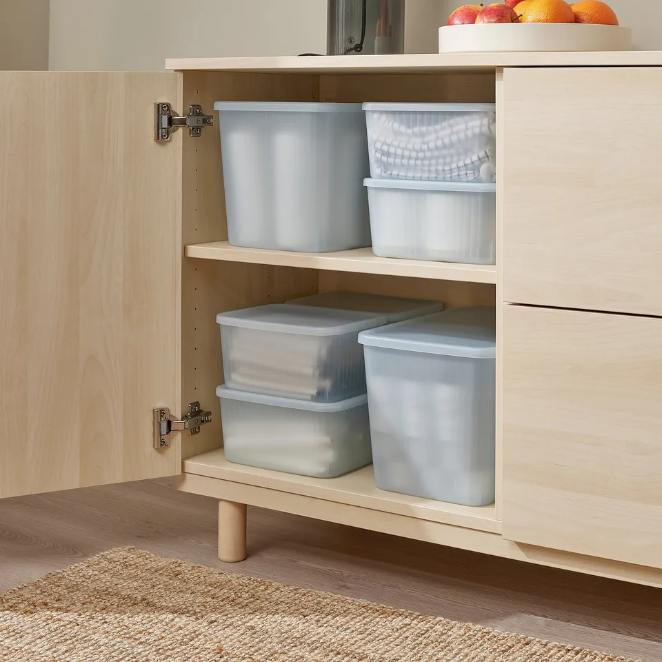 Wooden cabinet with light blue storage bins, stacked and visible, ideal for organising small items and transparent for easy viewing.