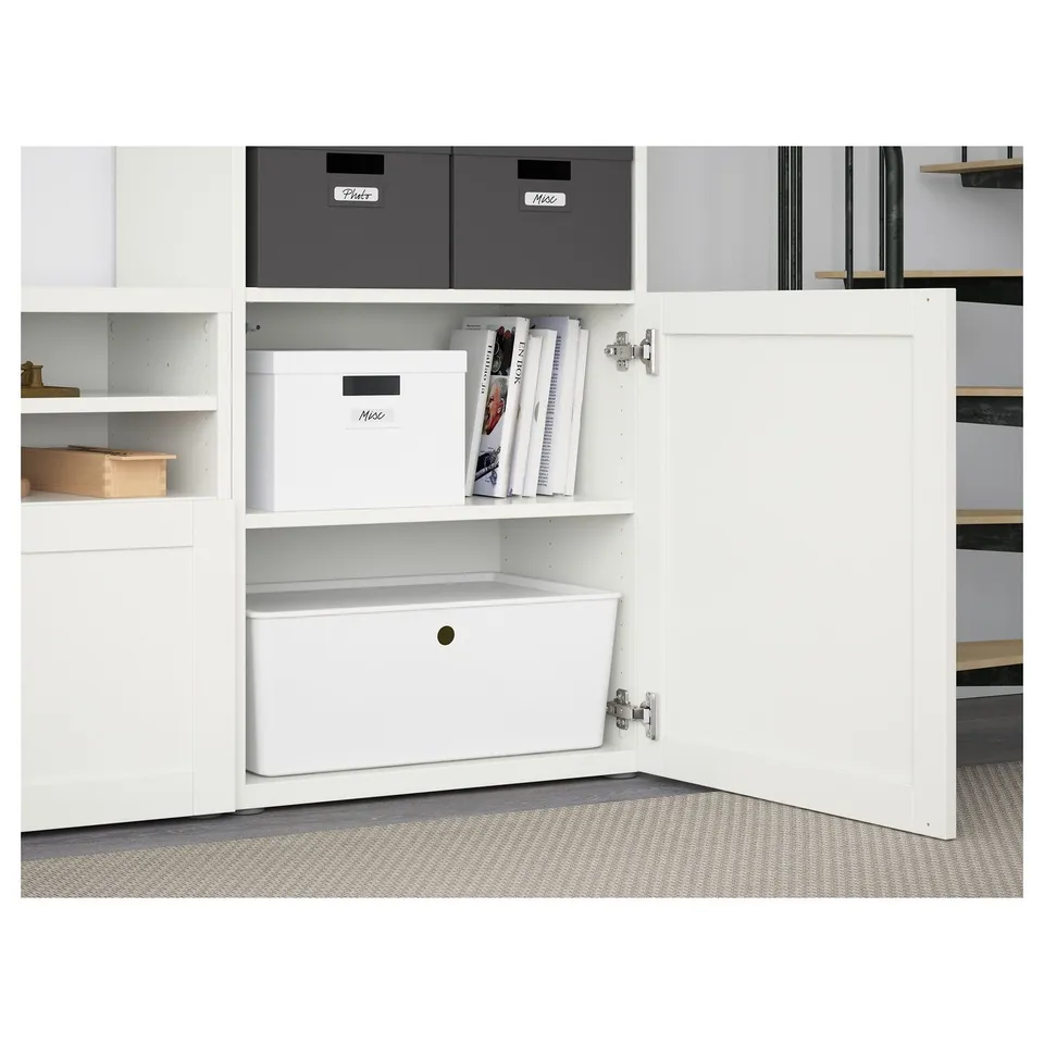 BESTÅ storage unit with shelves, drawers, cable management, and wall cabinets, showing organised items.