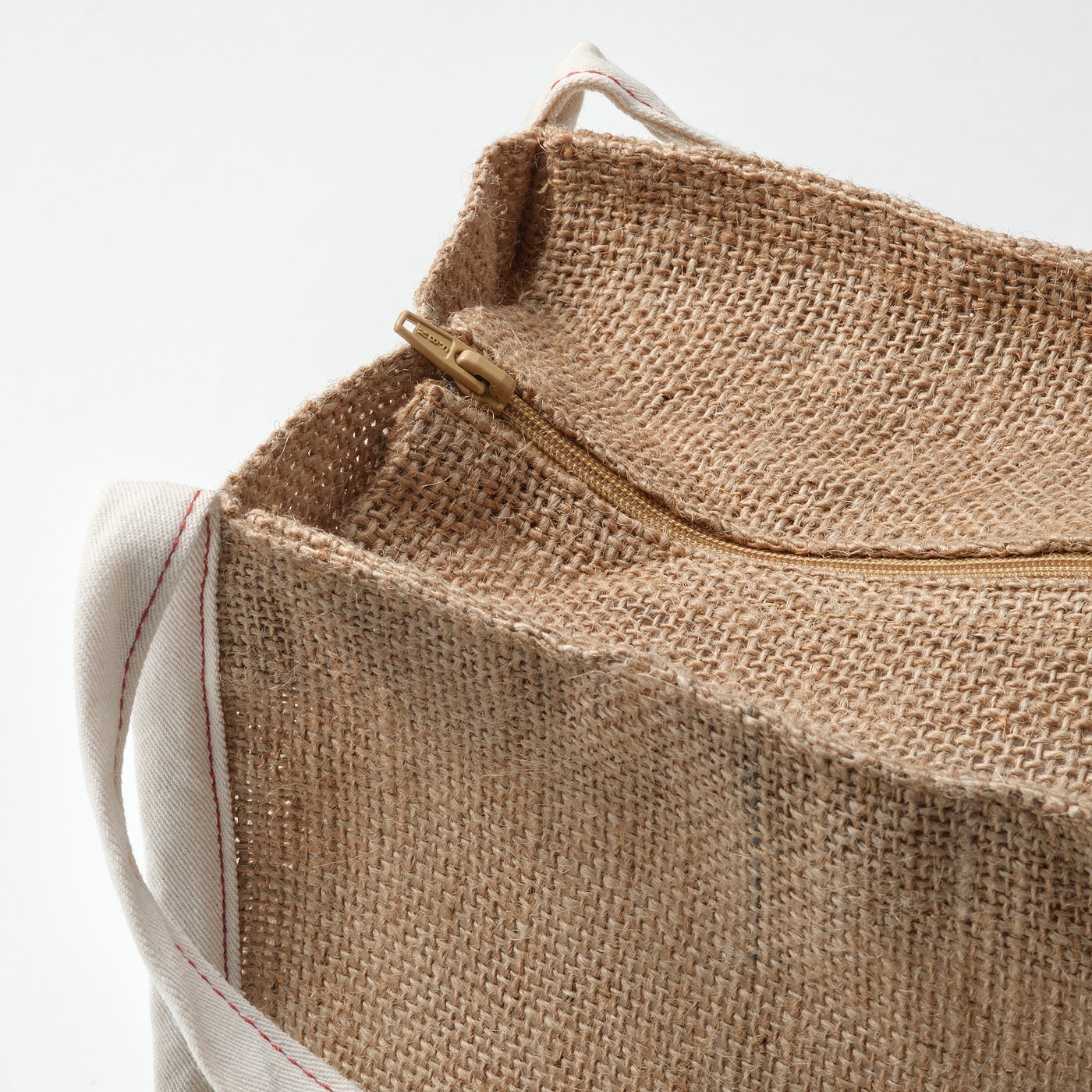 Close-up of durable jute storage bag with sturdy zip and handles, showcasing its high-quality craftsmanship.