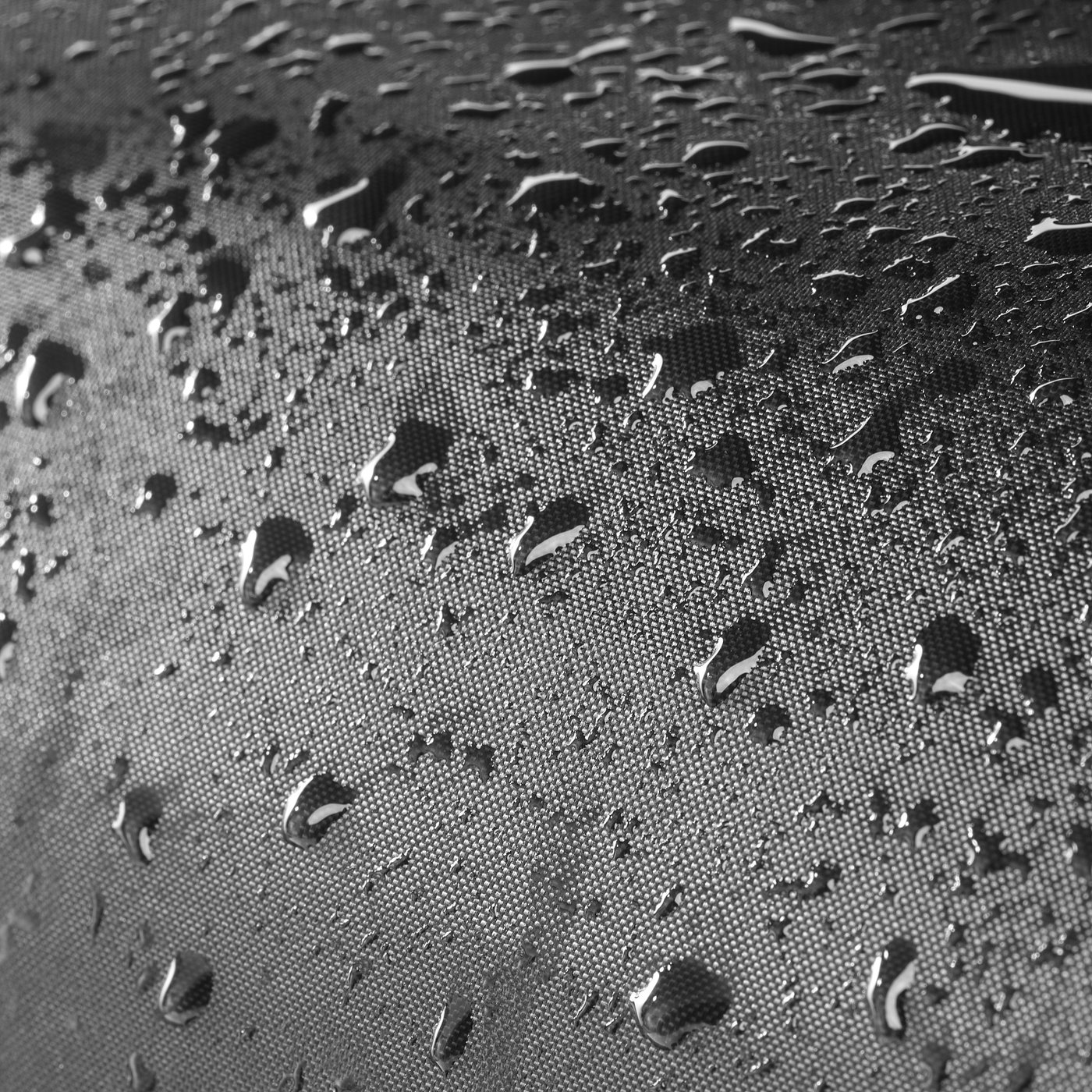 Water droplets on fabric, illustrating TOSTERÖs waterproof storage boxs protective function against rain.