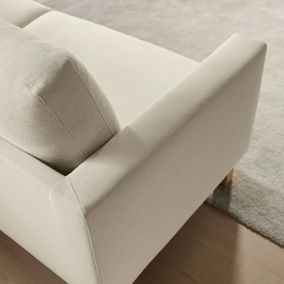 Modern sofa close-up, clean lines, supportive cushions.