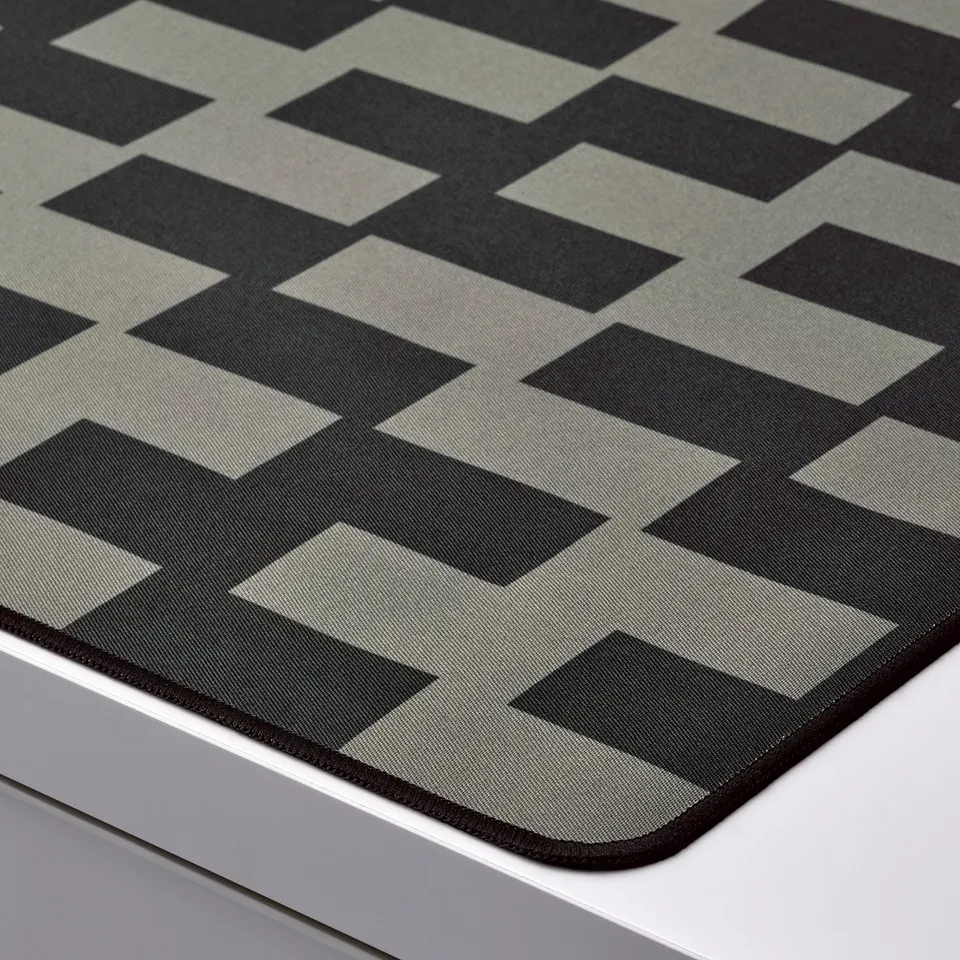 Black and grey patterned gaming mouse pad with smooth surface, firm grip, and recycled materials.